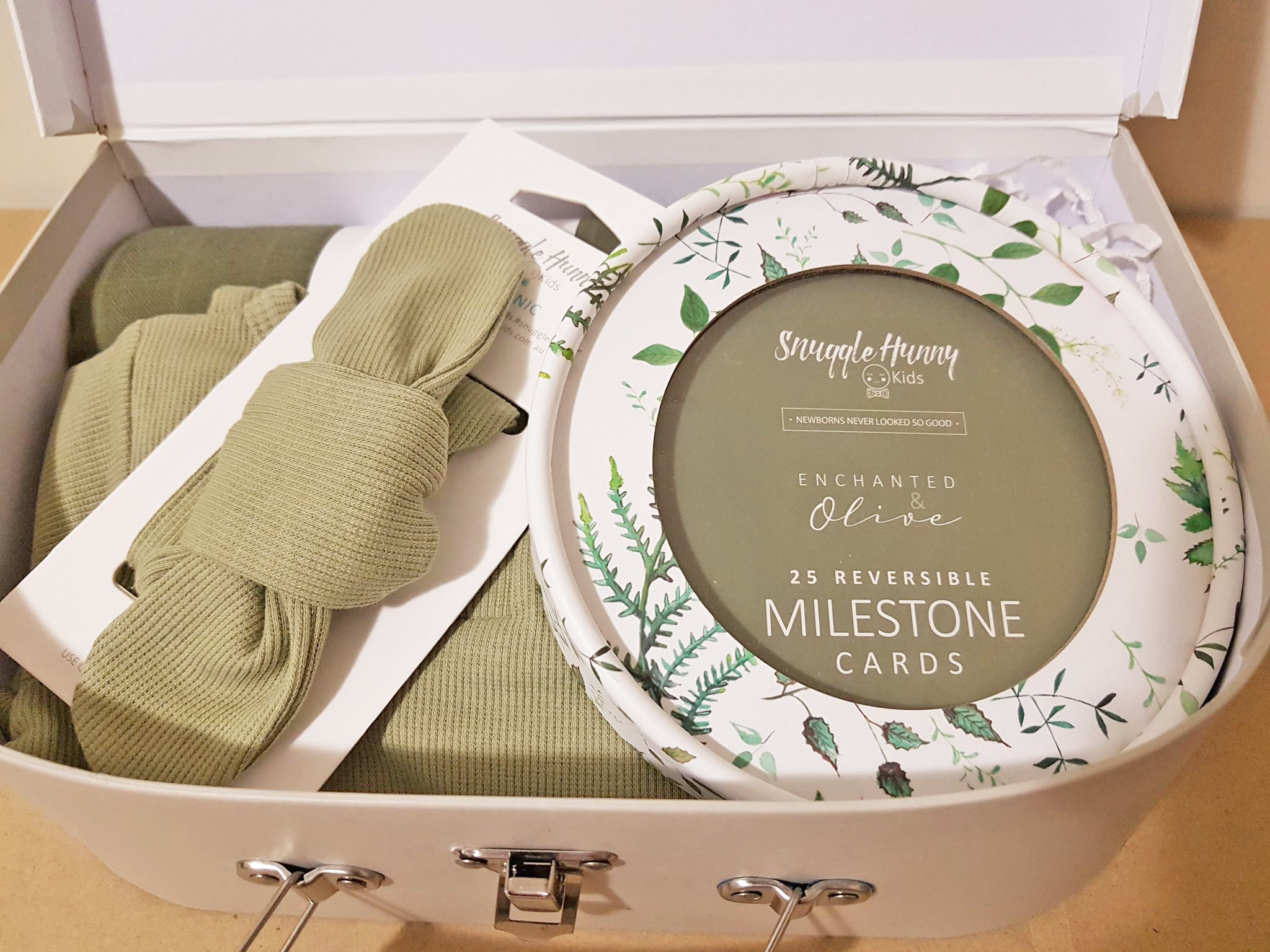 Small Snuggle Hunny Kids suitcase gift box for newborn baby girl green clothing muslin and milestone cards